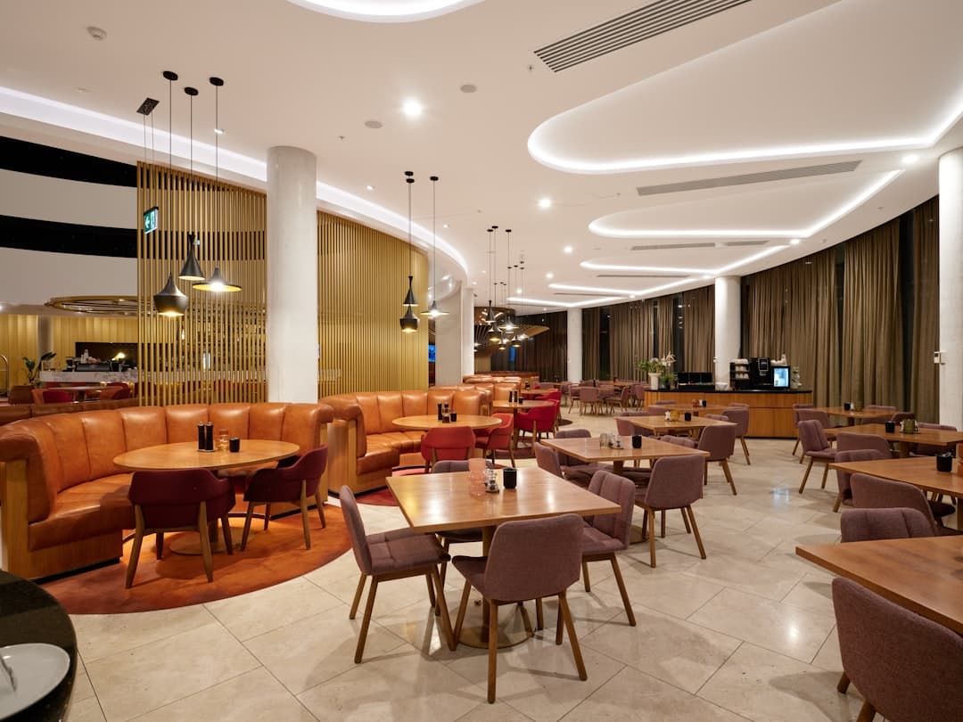 Modern restaurant interior with booth seating and tables. — Photo by Neon Wang on Unsplash
