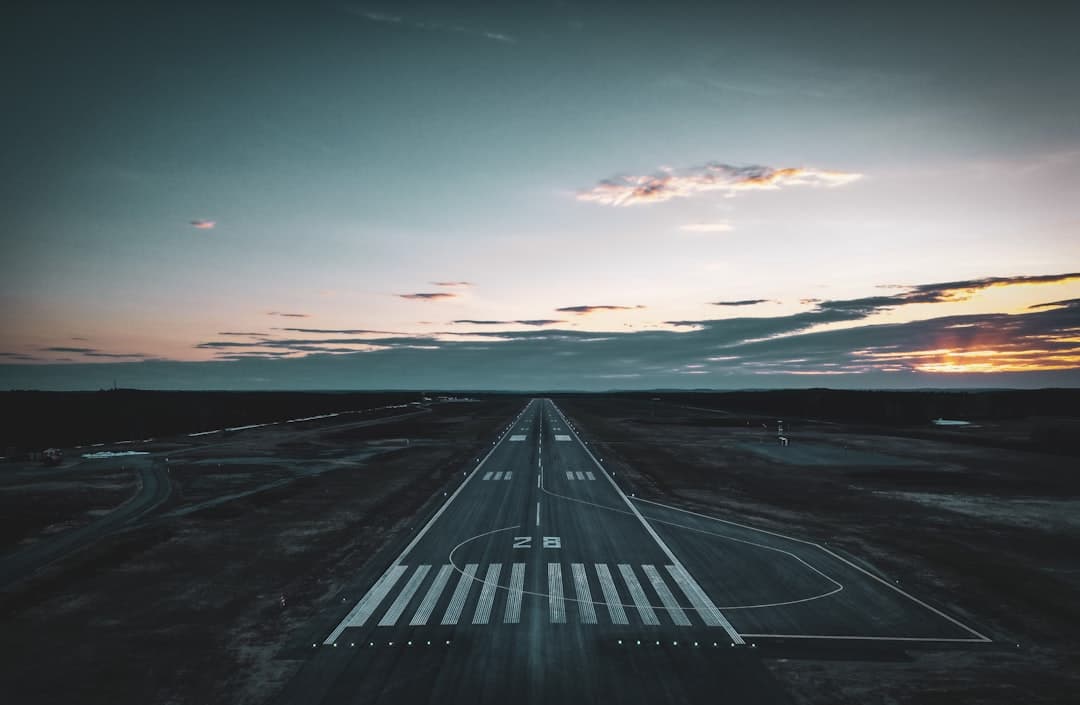 an aerial view of an airport runway at sunset — Photo by Niklas Jonasson on Unsplash