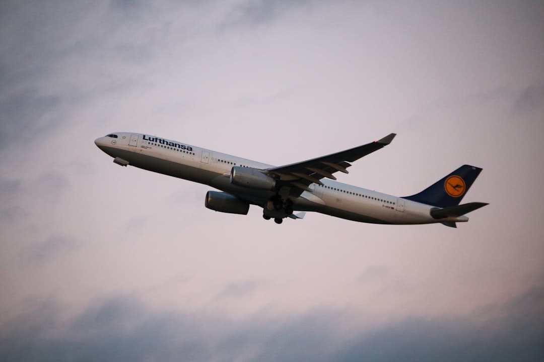 white and blue airplane under white clouds during daytime — Photo by Matt Boucher on Unsplash