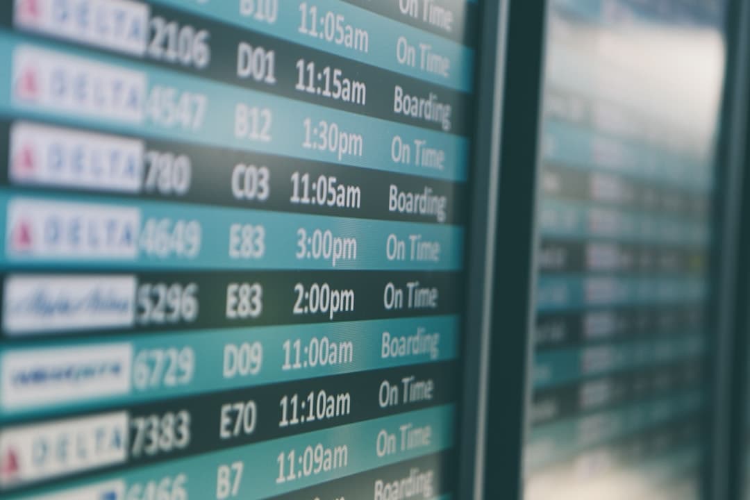 Airport departures timetable showing Delta and Alaska Airlines flights on time and boarding — Photo by Matthew Smith on Unsplash