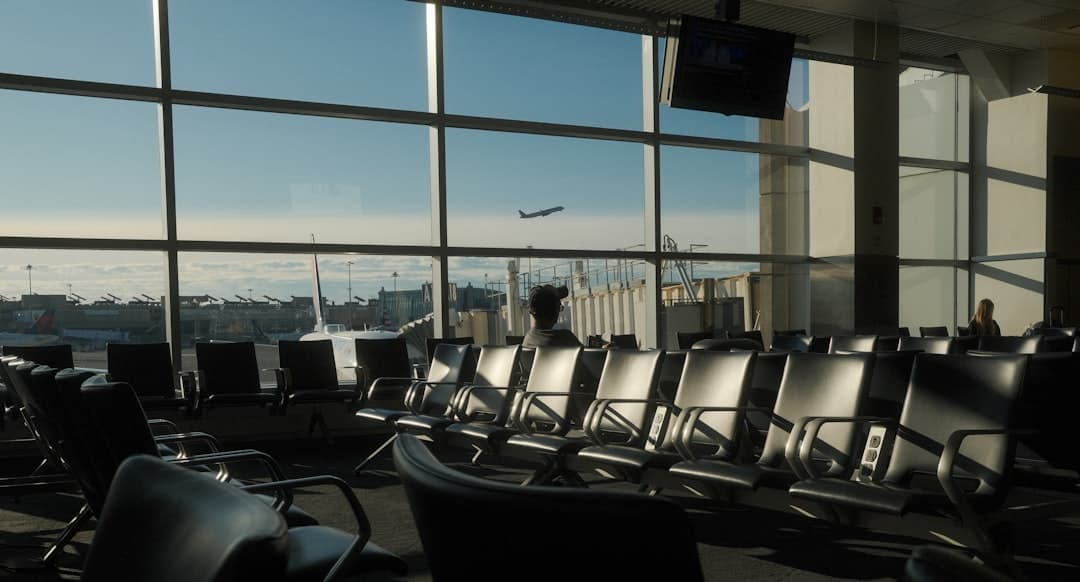Airport terminal with a plane taking off. — Photo by Kaden Taylor on Unsplash