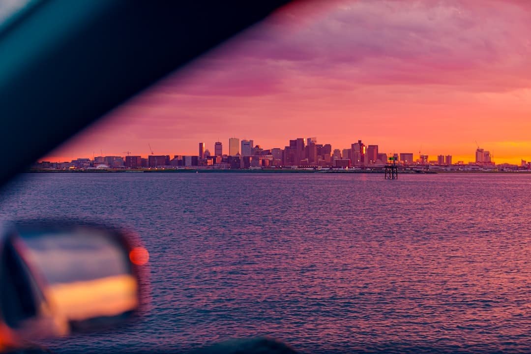 city skyline near body of water during dusk — Photo by todd kent on Unsplash