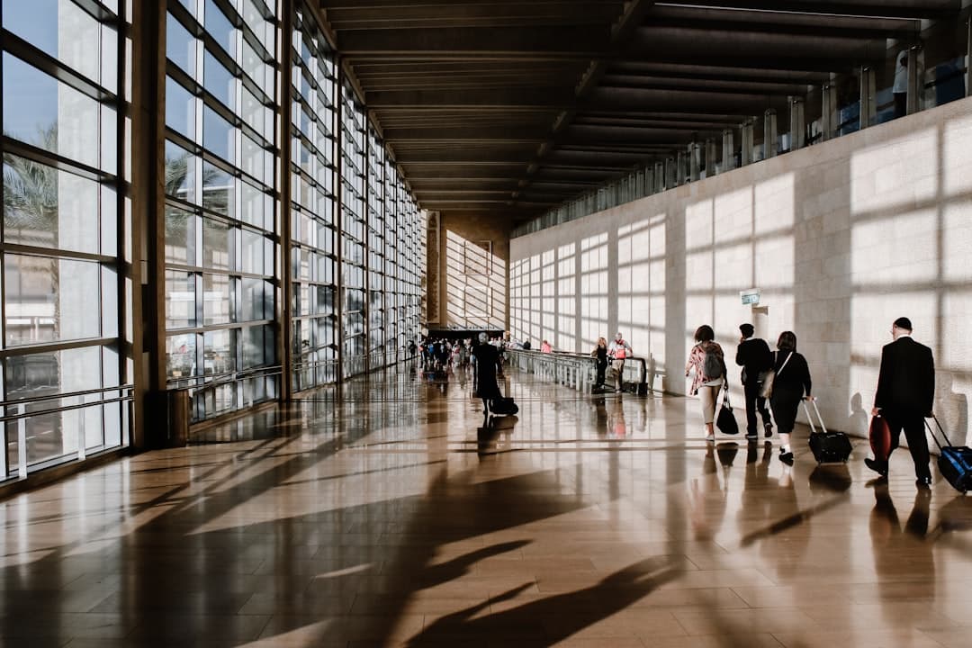 group of people walking beside white building — Photo by Briana Tozour on Unsplash