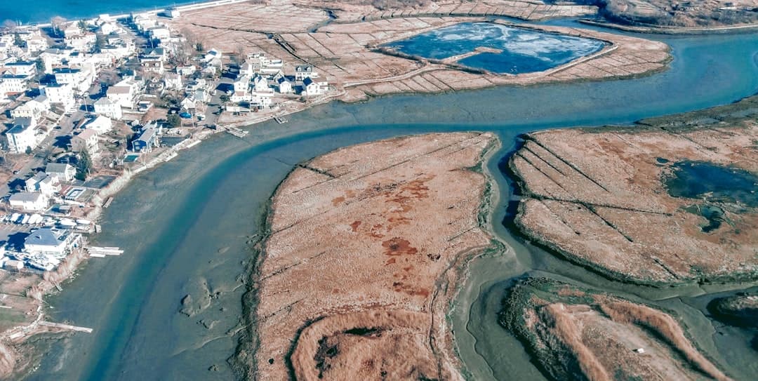 an aerial view of a river running through a city — Photo by BP Miller on Unsplash
